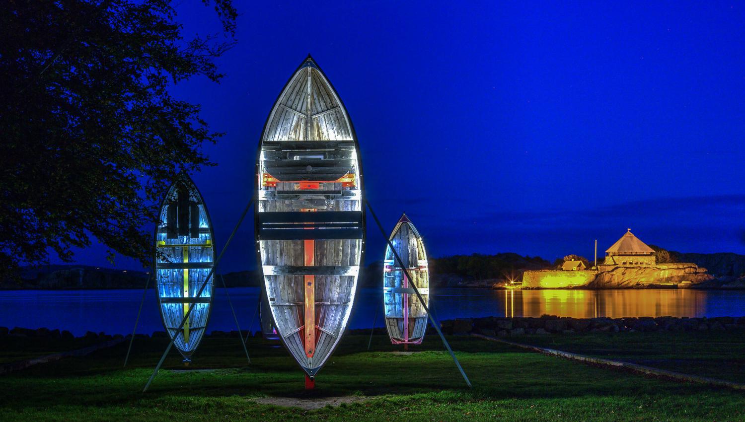 Old wooden boats are standing tall with lights inside