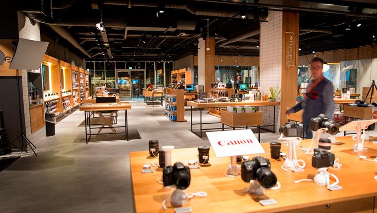An assortment of cameras from the brand Canon on a table.