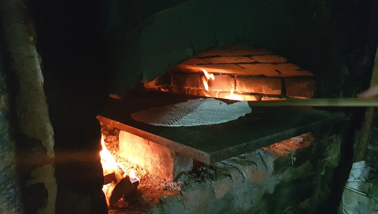 The "krotakaker" are being made in an open wood burning oven