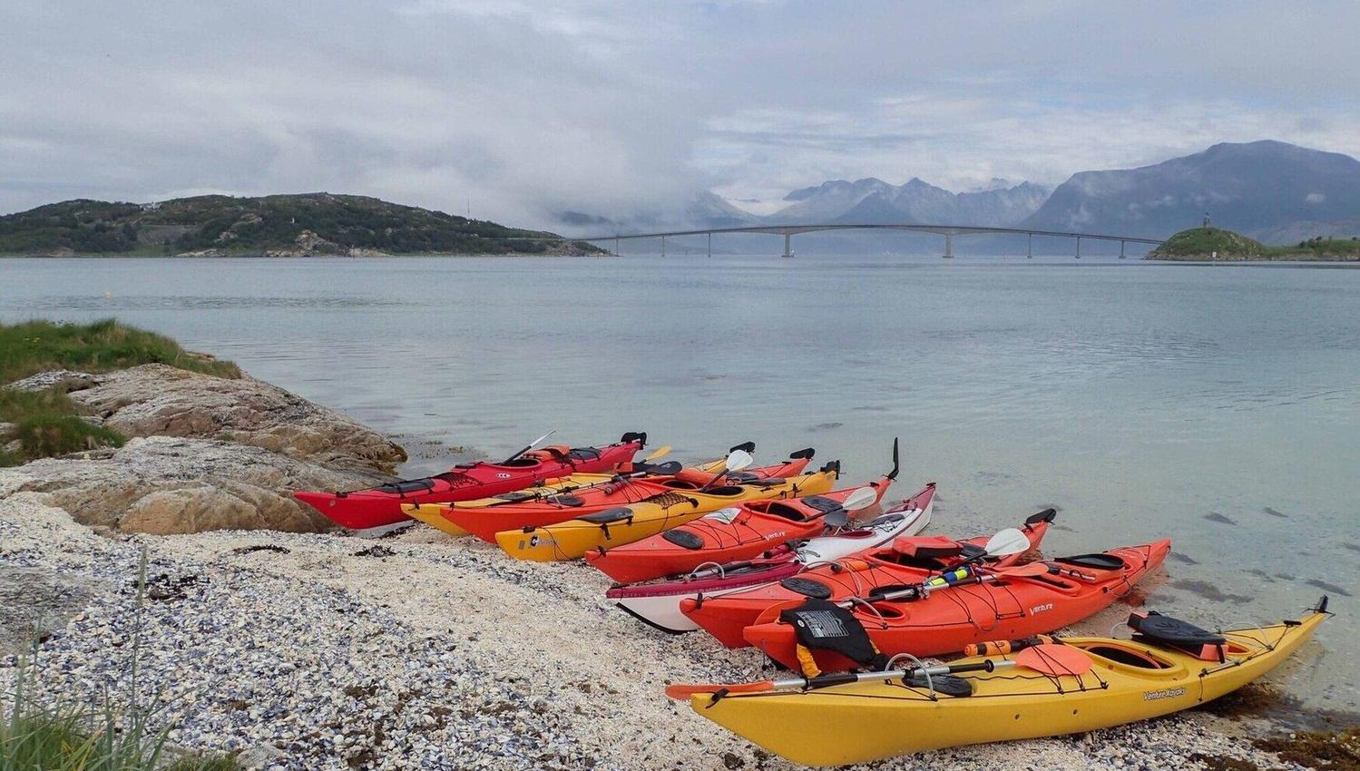 kayaks on a beach with views towards the bridge over to Sommarøy