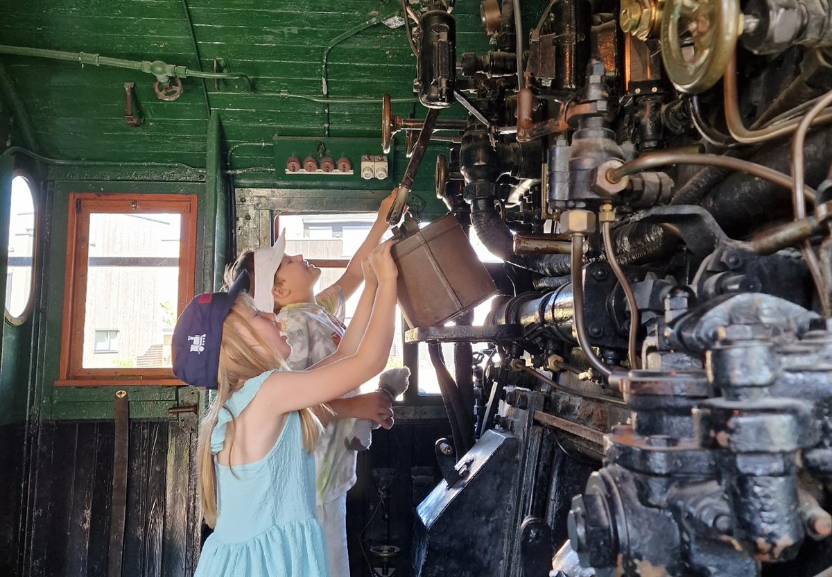 Person working with a large machine in an industrial setting.