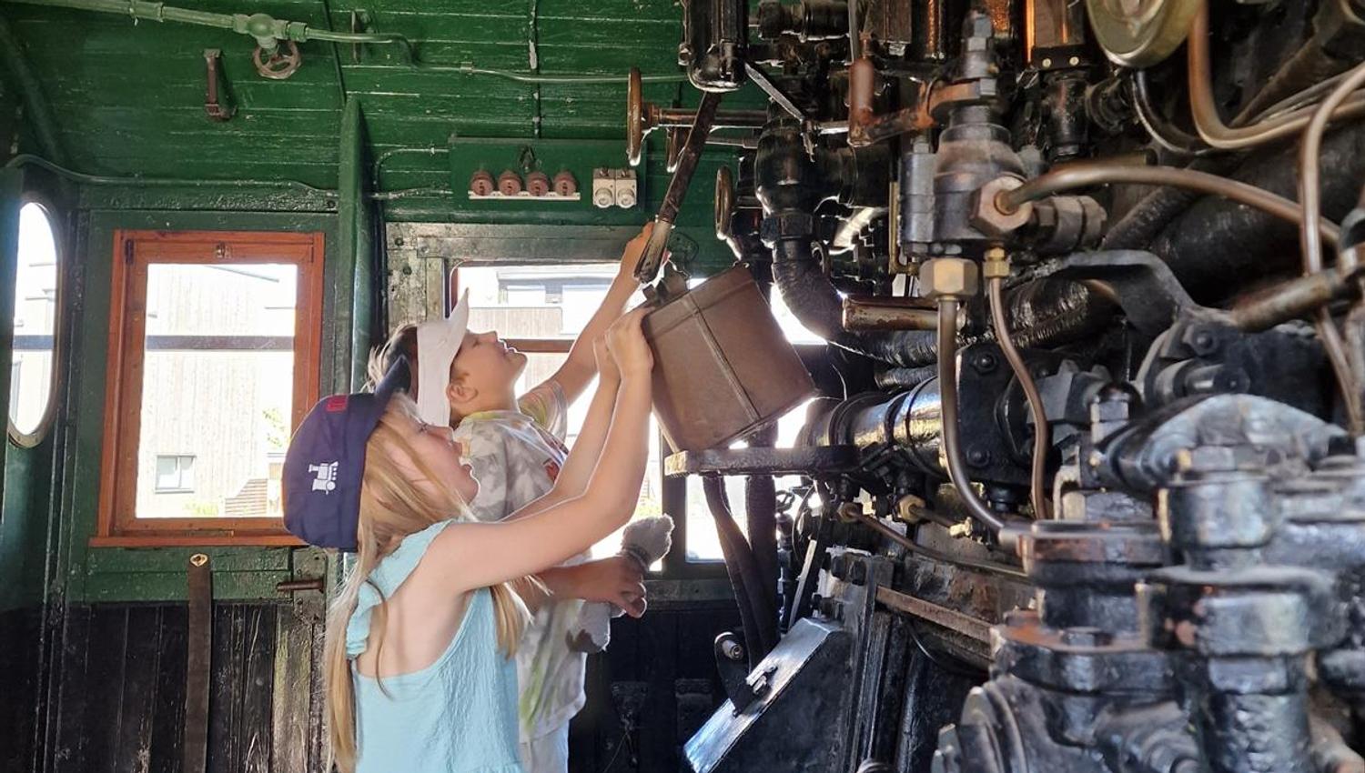 Person working with a large machine in an industrial setting.