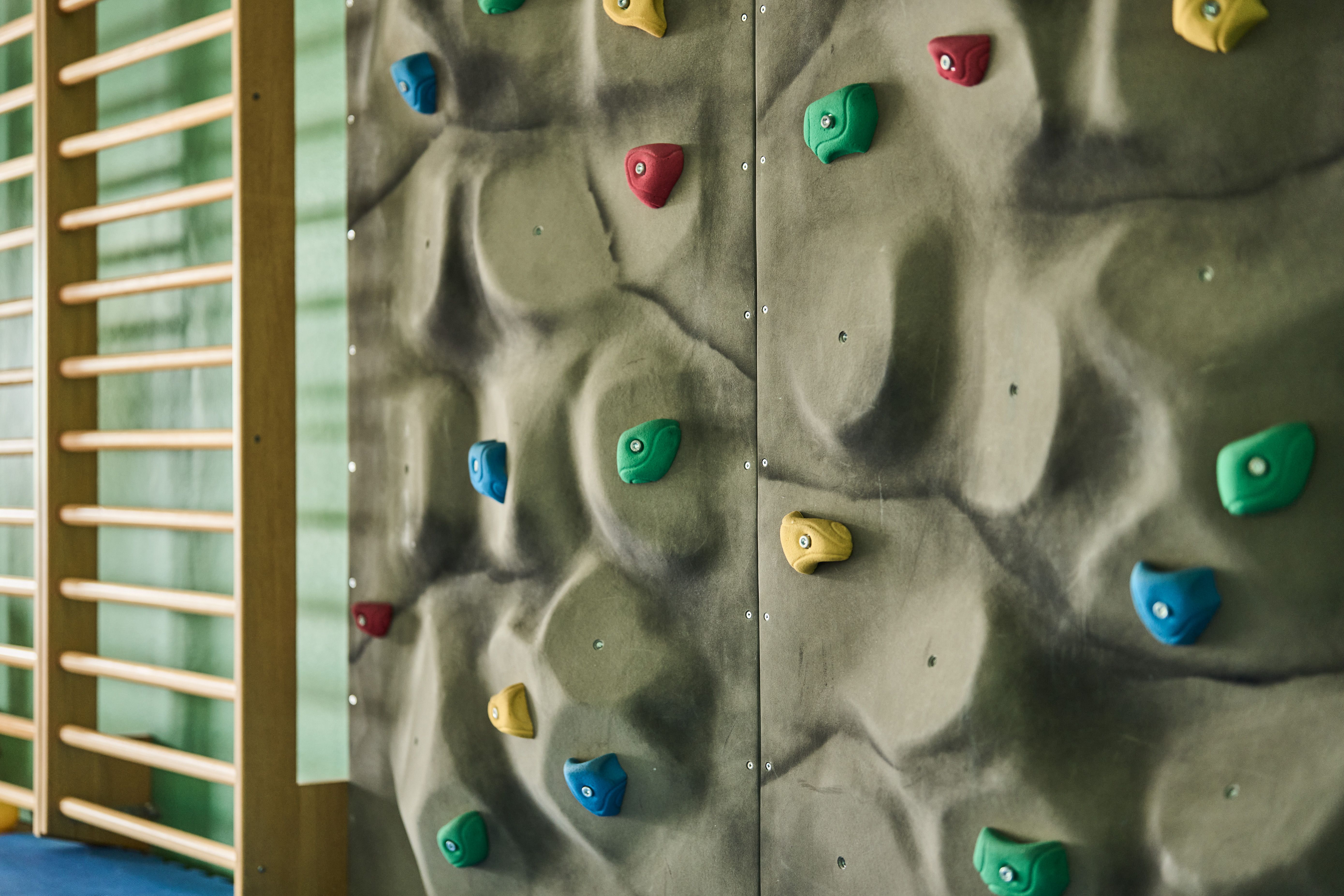 Colorful climbing wall at the Hotel Ullensvang activity center – fun for all ages.