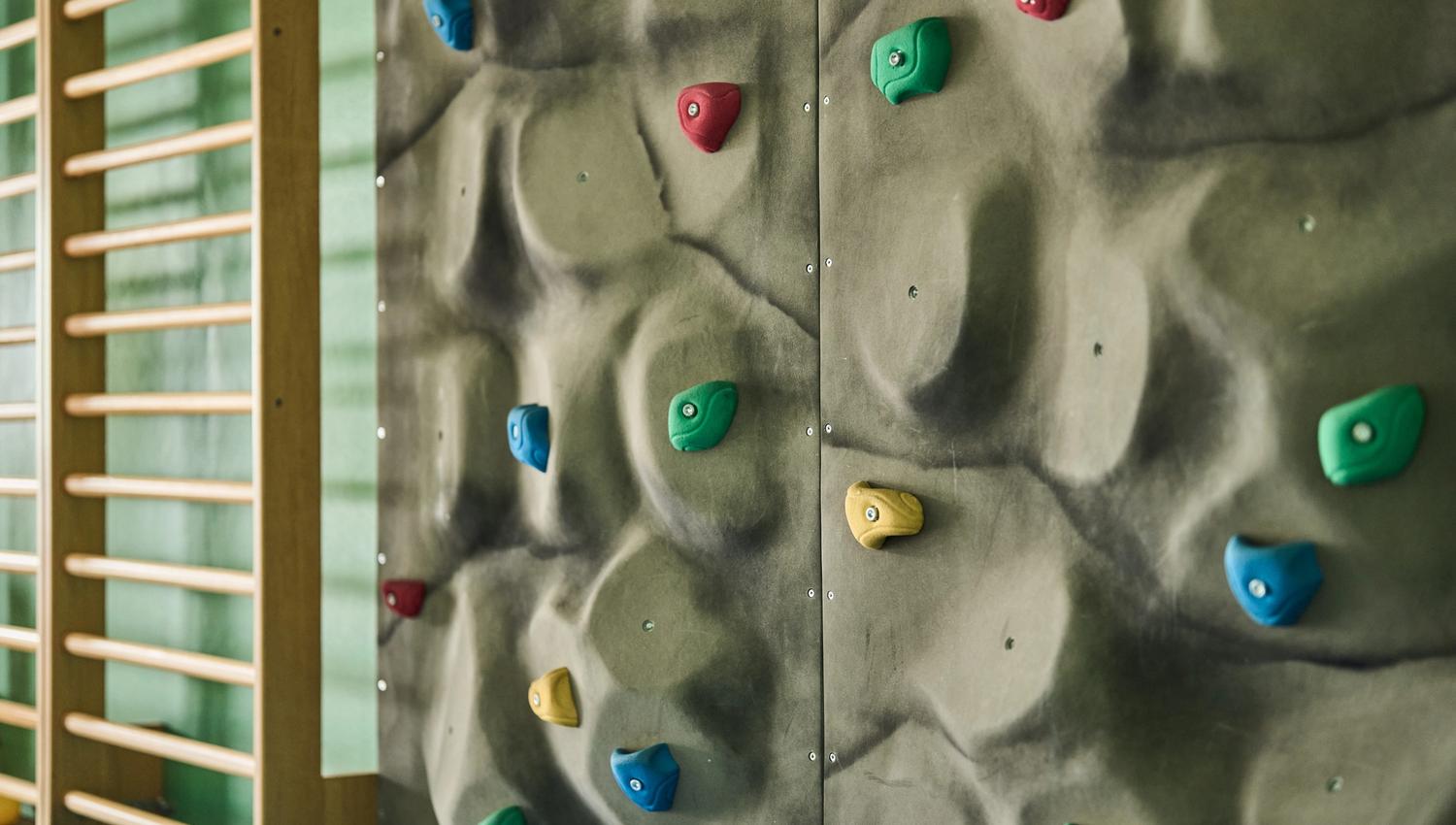 Colorful climbing wall at the Hotel Ullensvang activity center – fun for all ages.