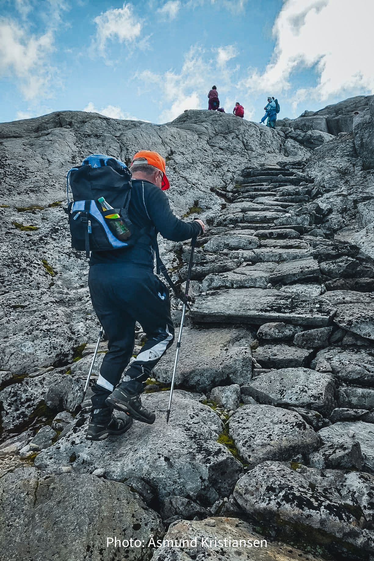 Hiker climbing stone steps in the high mountains of Hardanger, Norway, a classic hiking experience