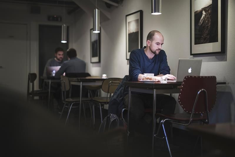 people with computers inside the coffee shop