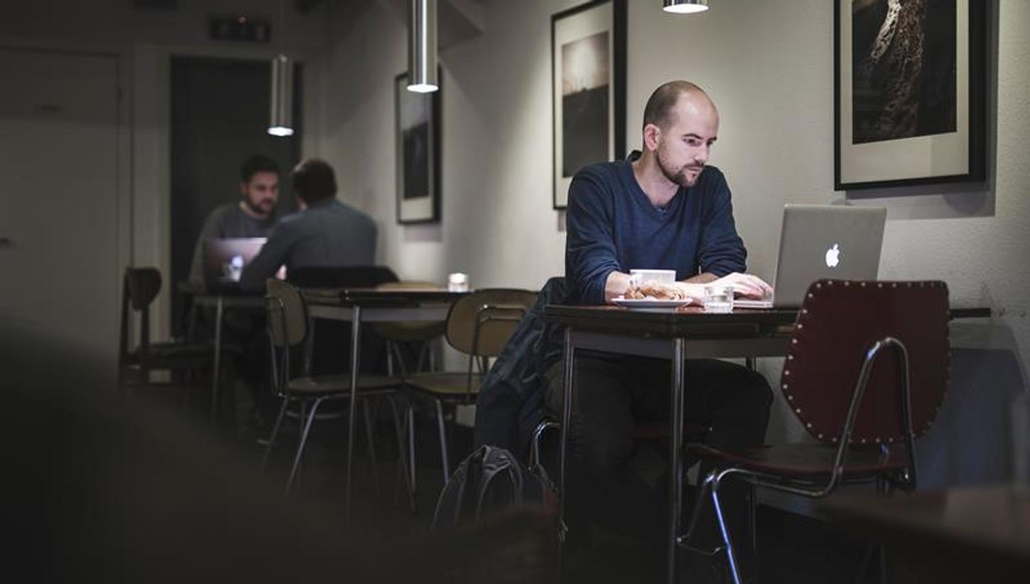 people with computers inside the coffee shop