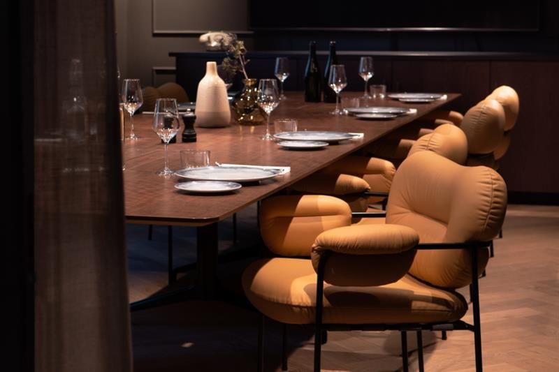 Conference table set for dining and comfortable chairs.