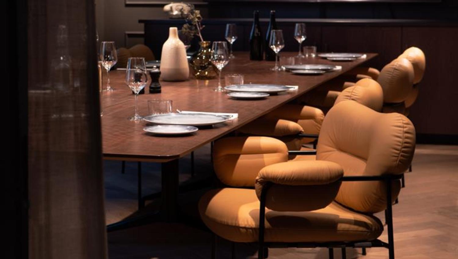 Conference table set for dining and comfortable chairs.