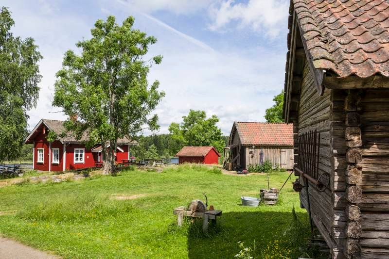 a small farm with a red main building 