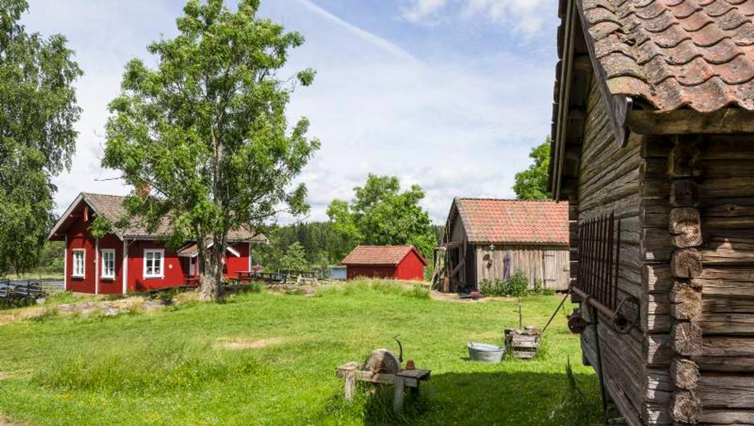 a small farm with a red main building