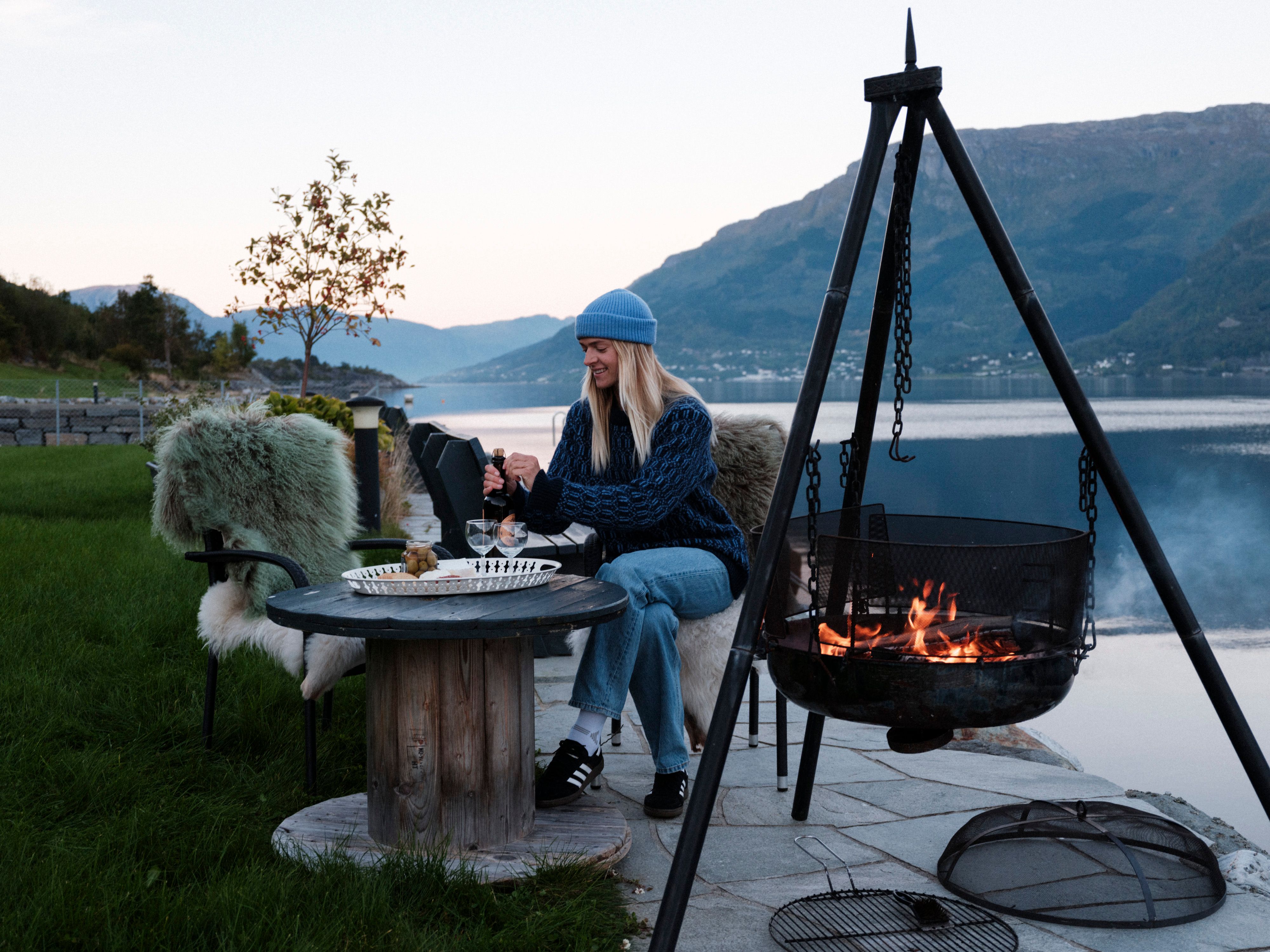 Cozy outdoor area with fire pit and panoramic view from Aga Fjordapartments.