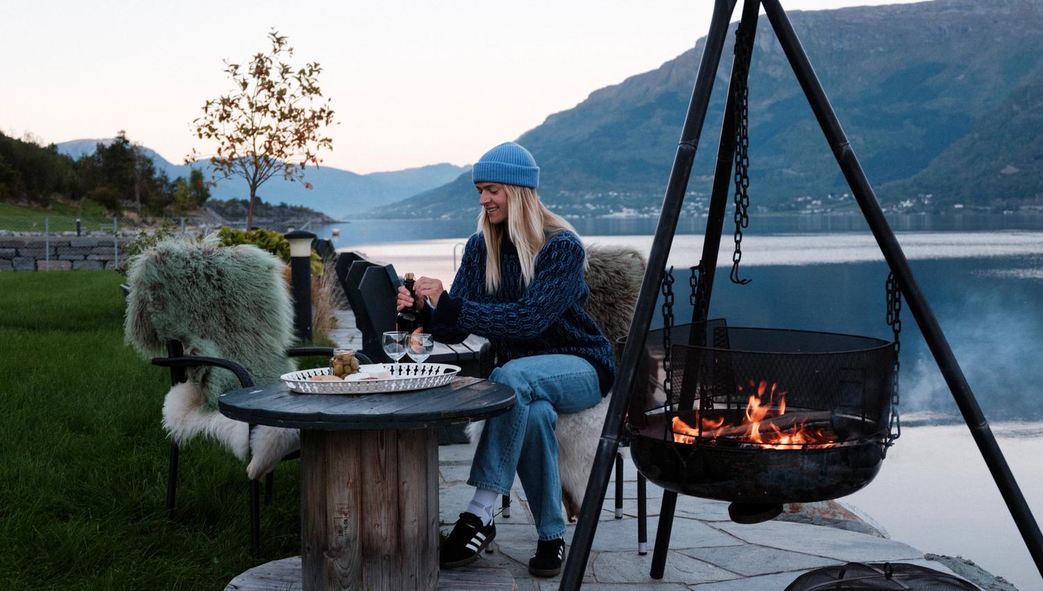 Cozy outdoor area with fire pit and panoramic view from Aga Fjordapartments.