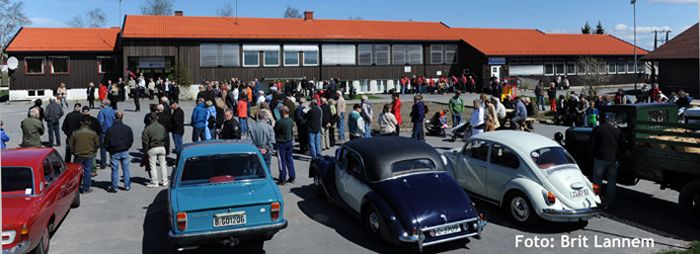Old cars parked with people around