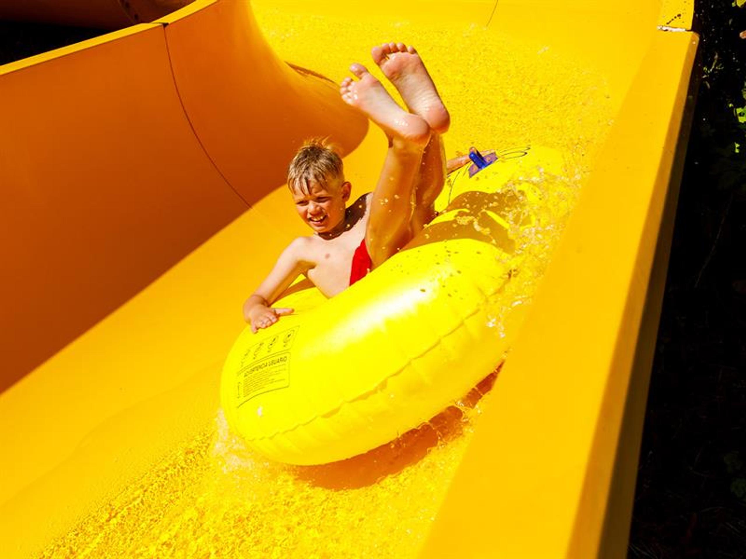 Boy coming down the water slide