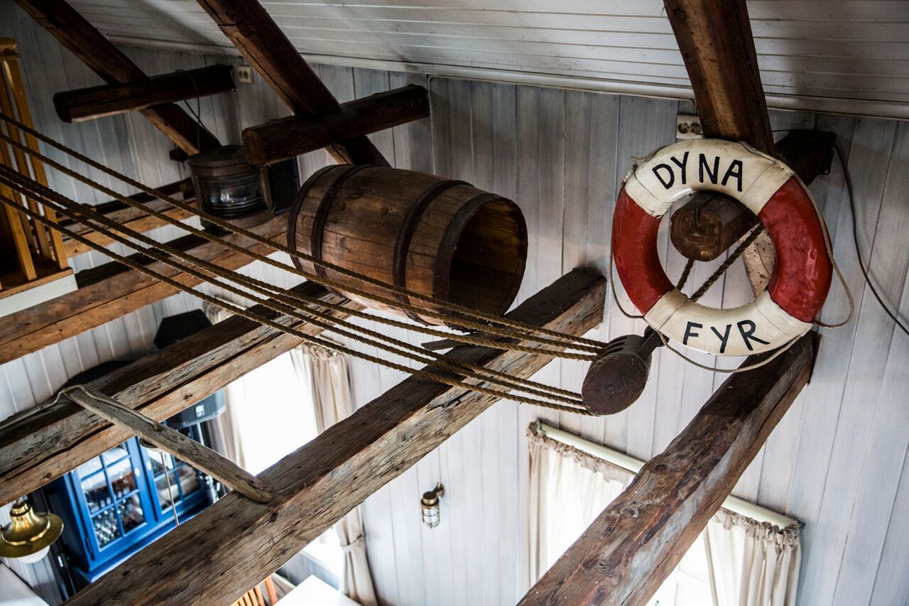 Interior of Dyna fyr, with ceiling beams, a barrel and a buoy.