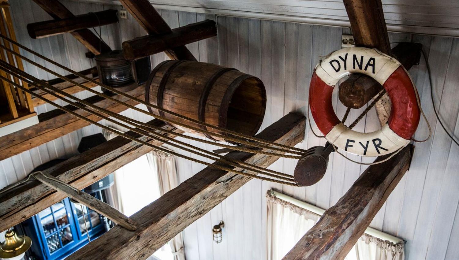 Interior of Dyna fyr, with ceiling beams, a barrel and a buoy.