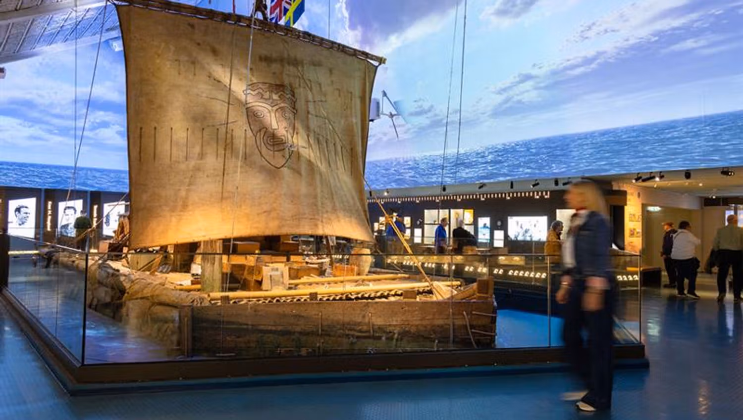 Person looking at the Kon-Tiki raft in the exhibition