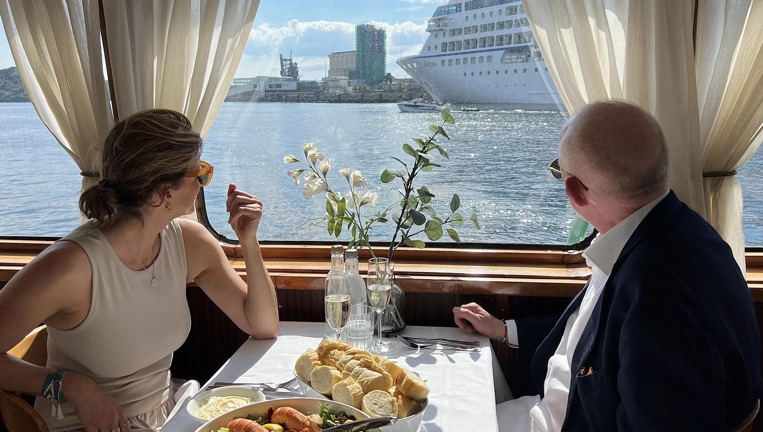 Two people enjoying seafood on board the boat