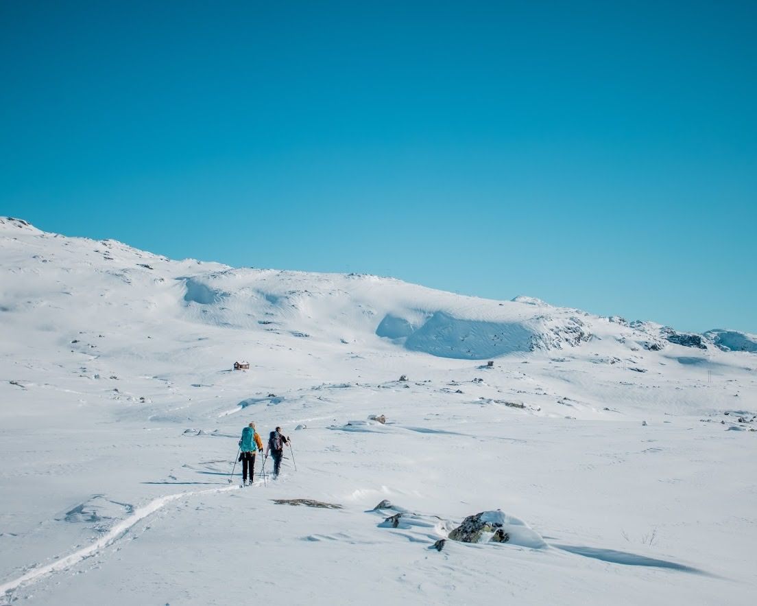 Group trekking across open winter mountain terrain on the way to Trolltunga.