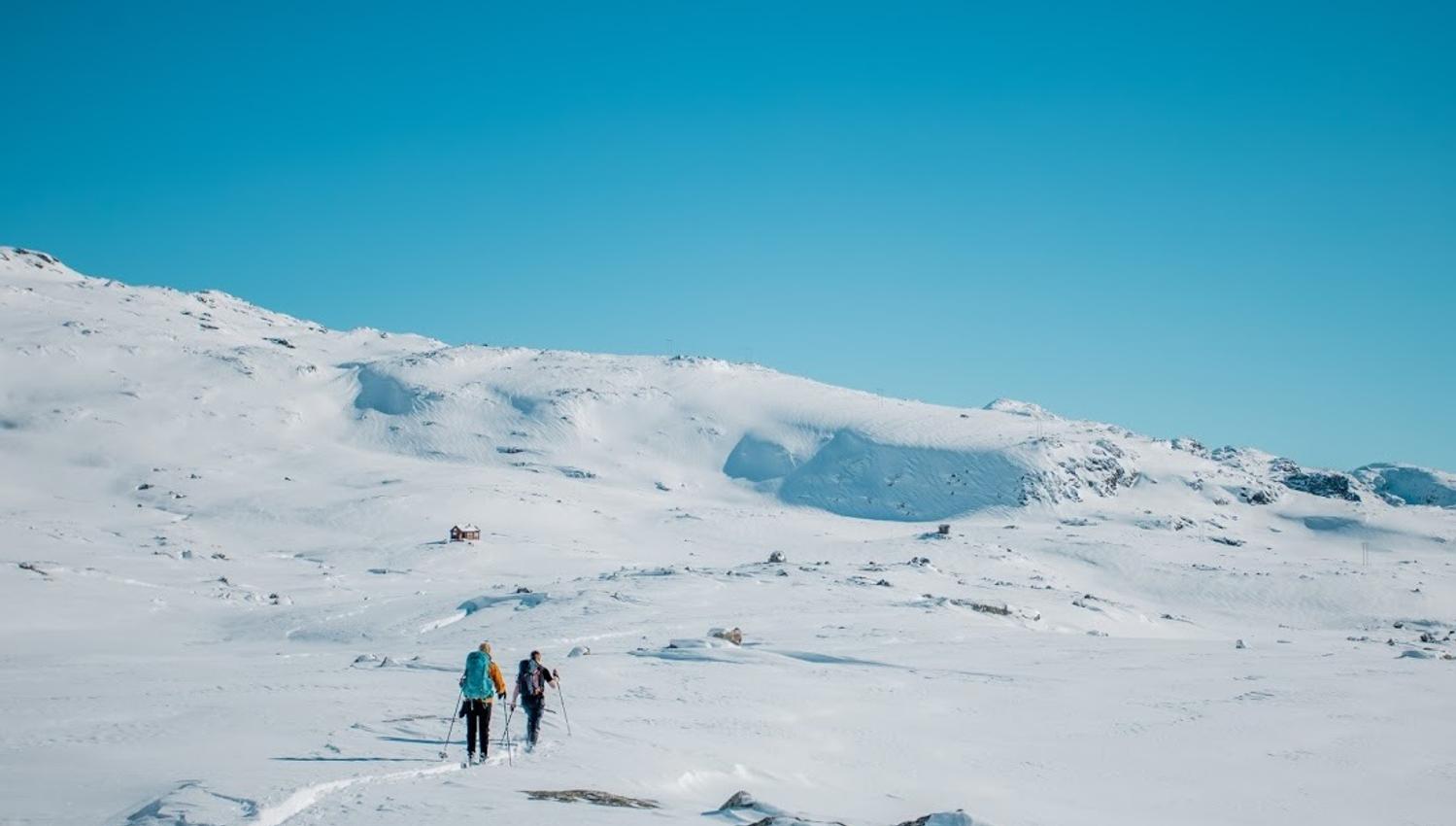 Group trekking across open winter mountain terrain on the way to Trolltunga.