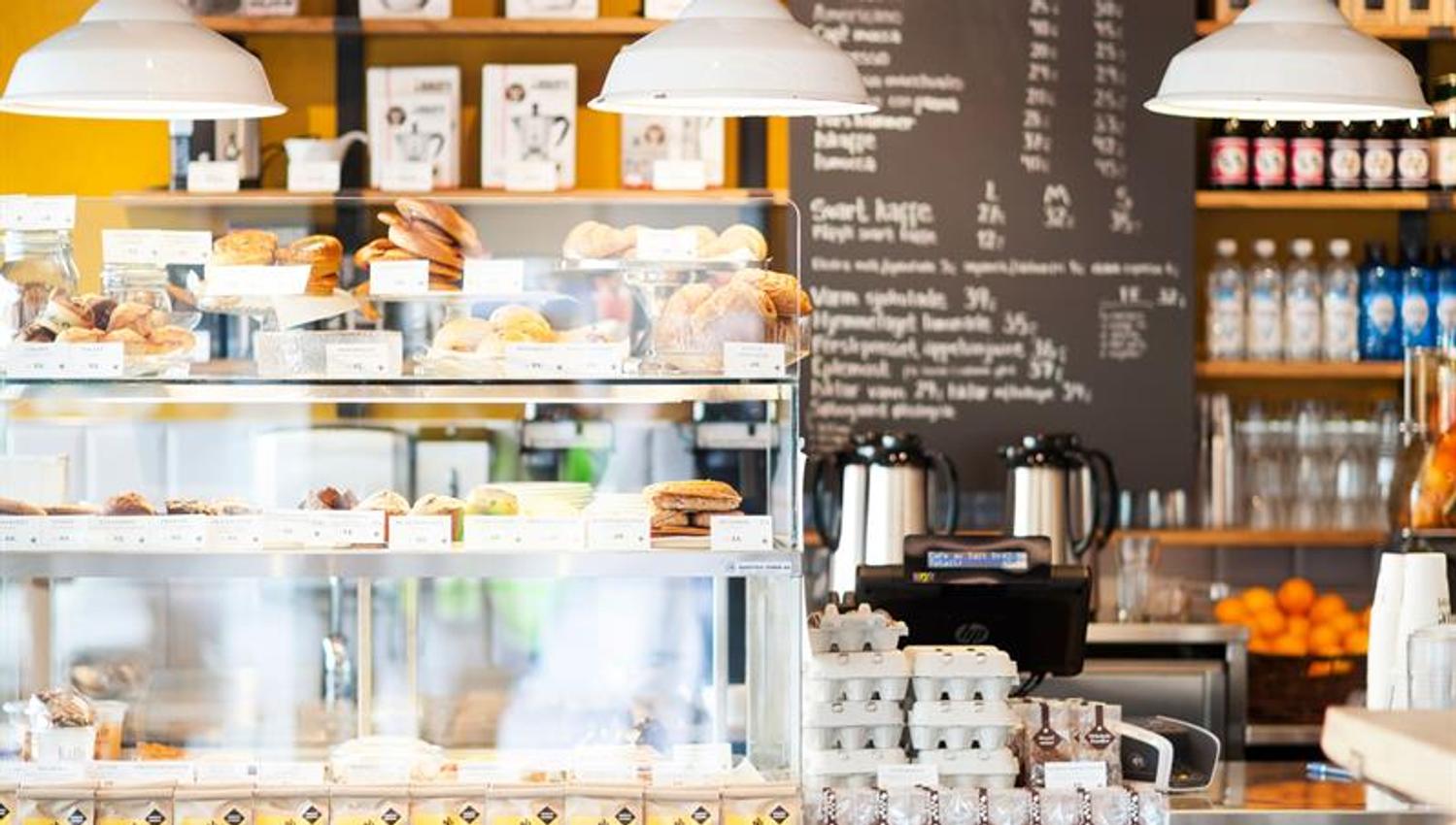 Counter, displayed baked goods and ceiling lamps.