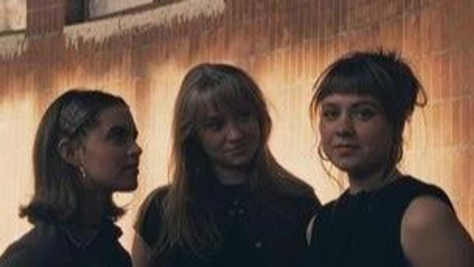A photo of the artists in ULD: Une, Lucia and Dagny standing side by side.