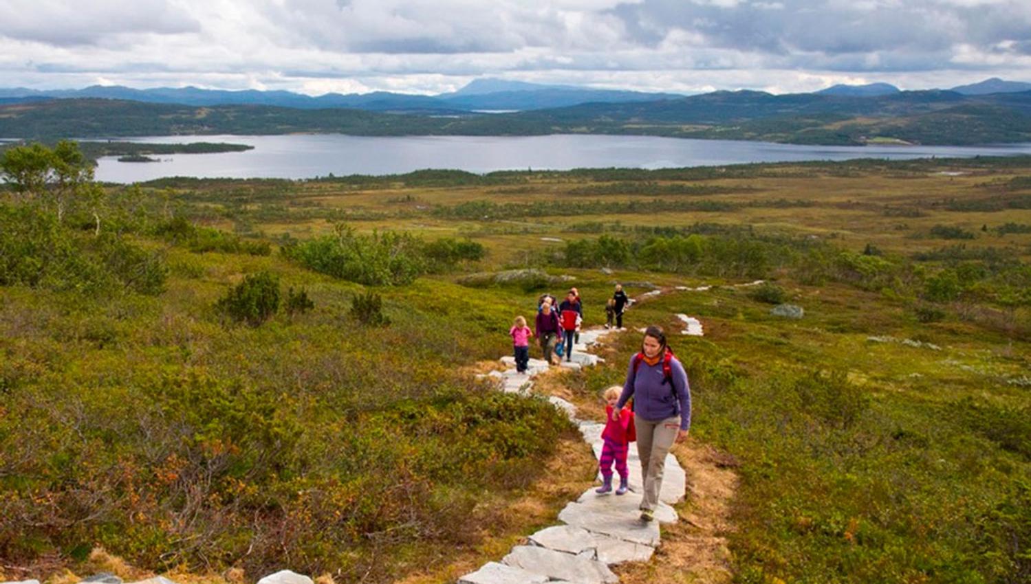 group of adults and children walking on the sherpastie