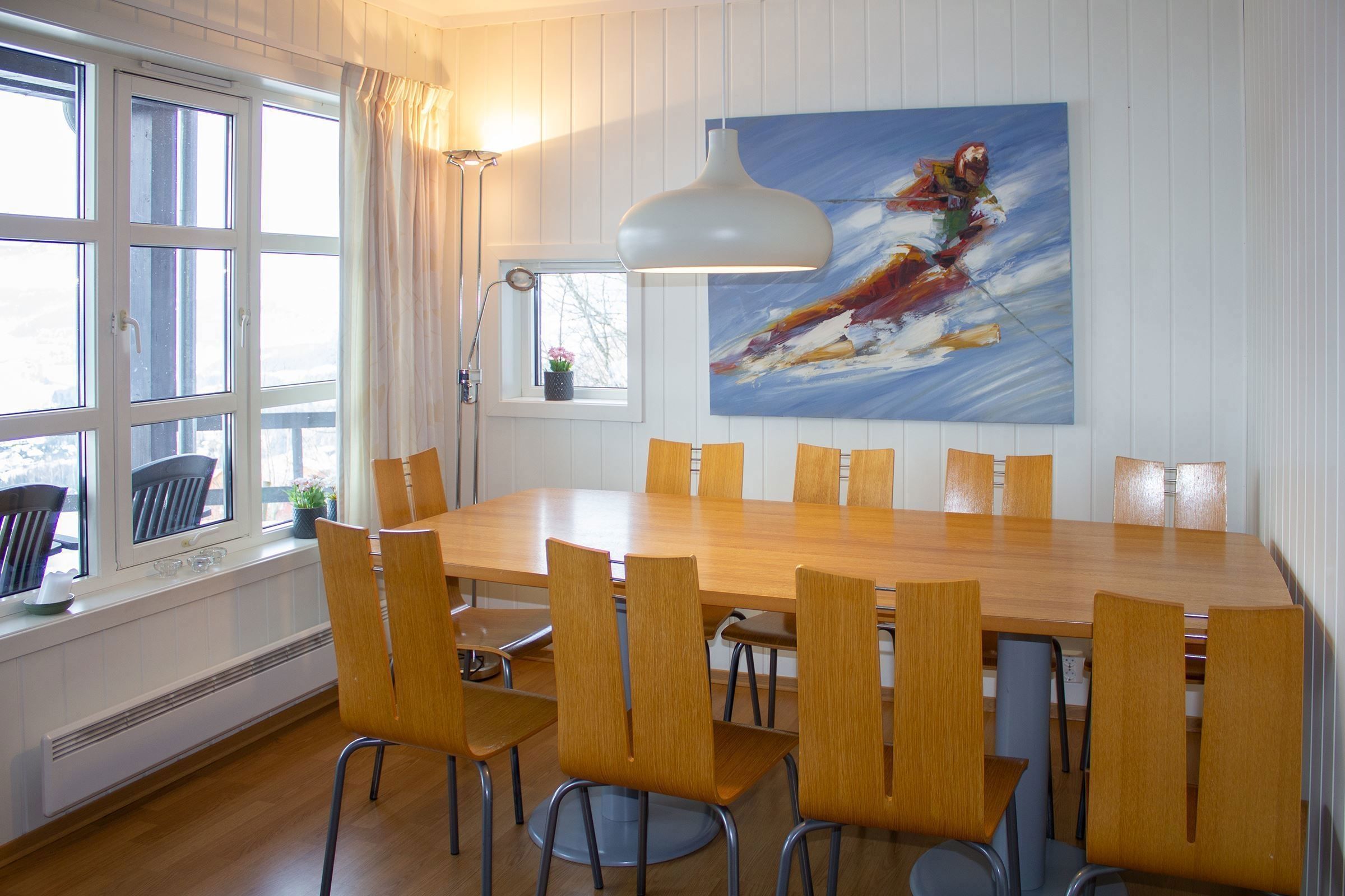 A dining room with table and chairs.