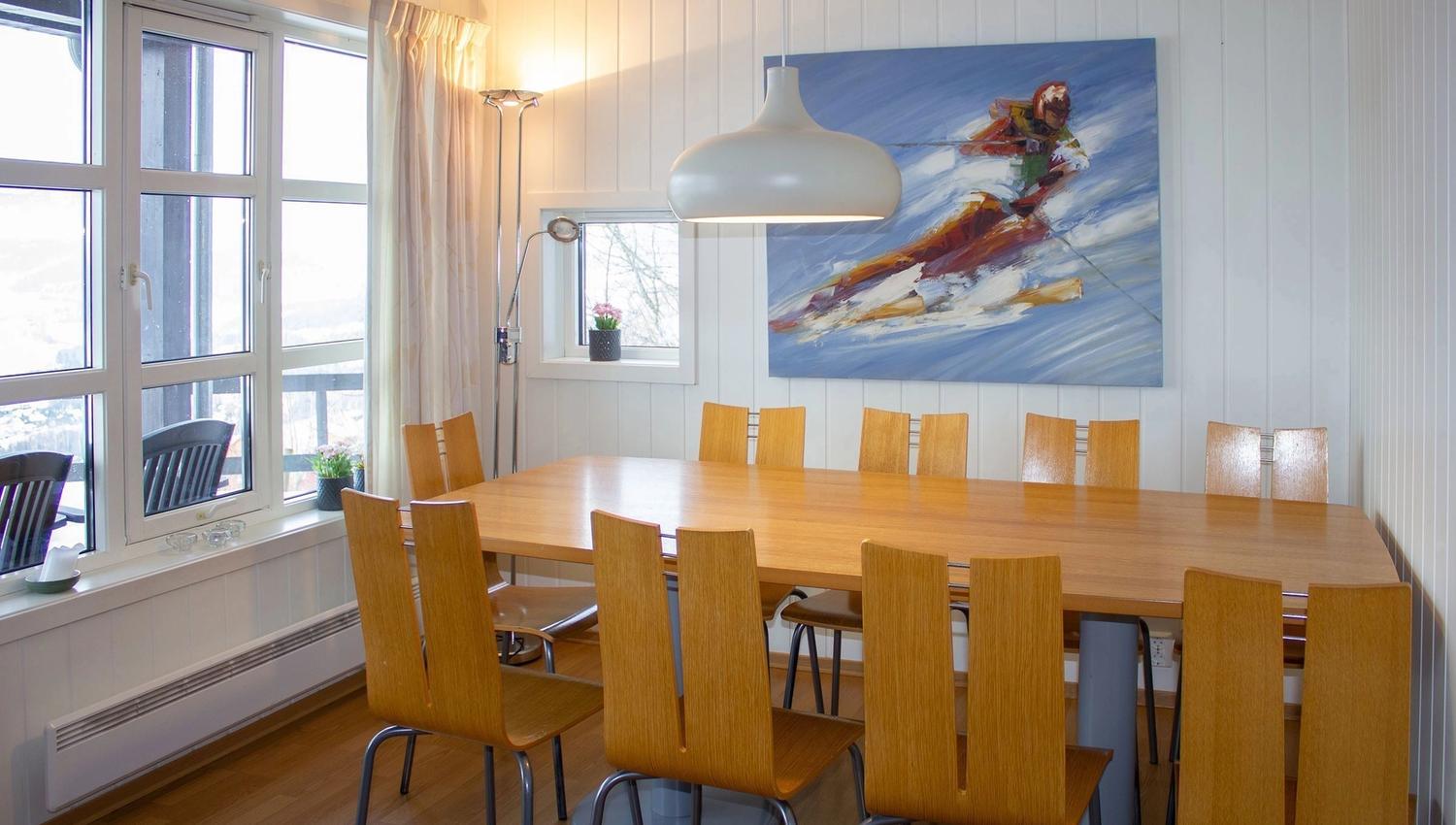 A dining room with table and chairs.