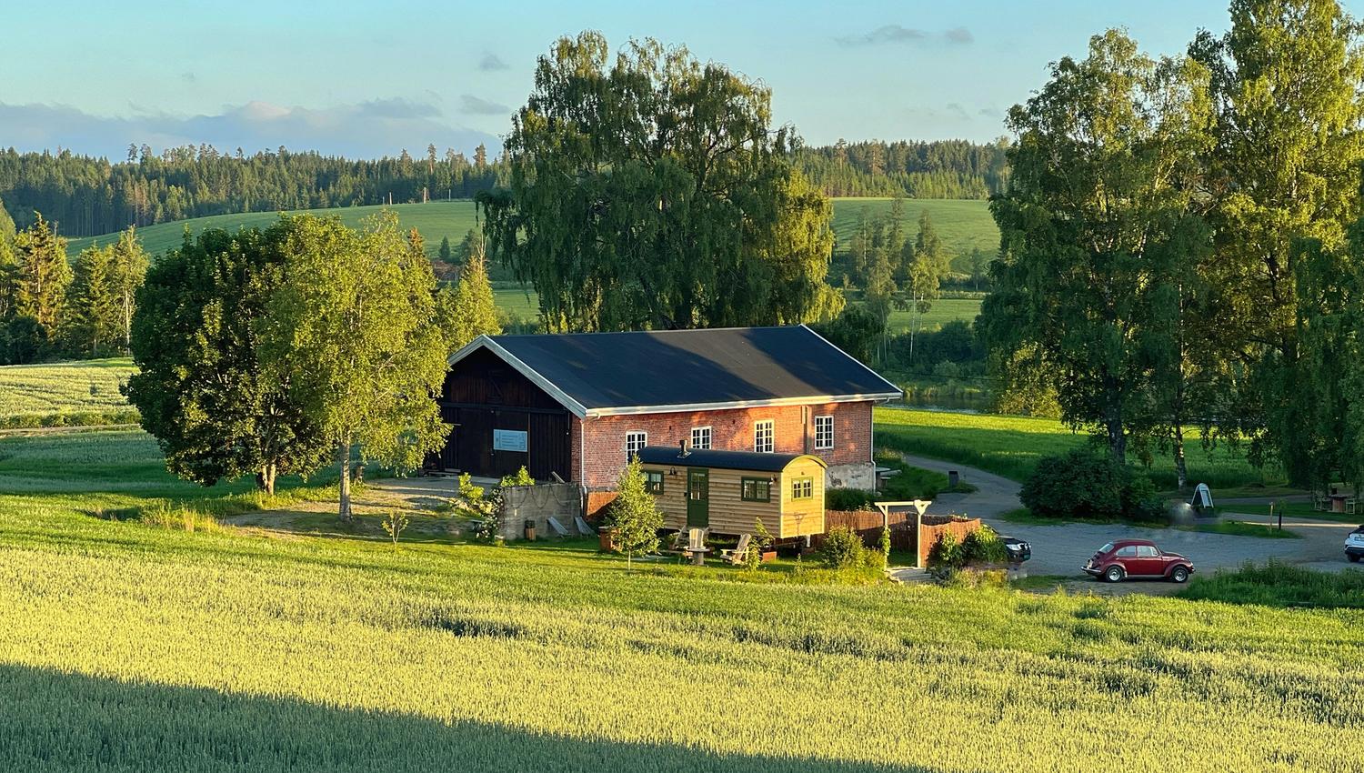 Shepherd´s Hut view fromabove with fields, barn and an old car