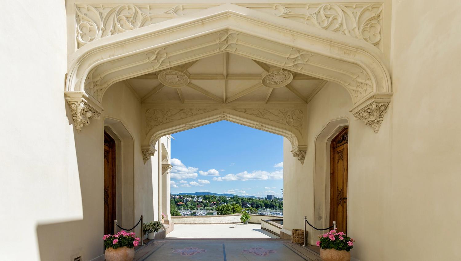 The entrance portal of Oscarshall with ornaments, flowers and views towards Oslo