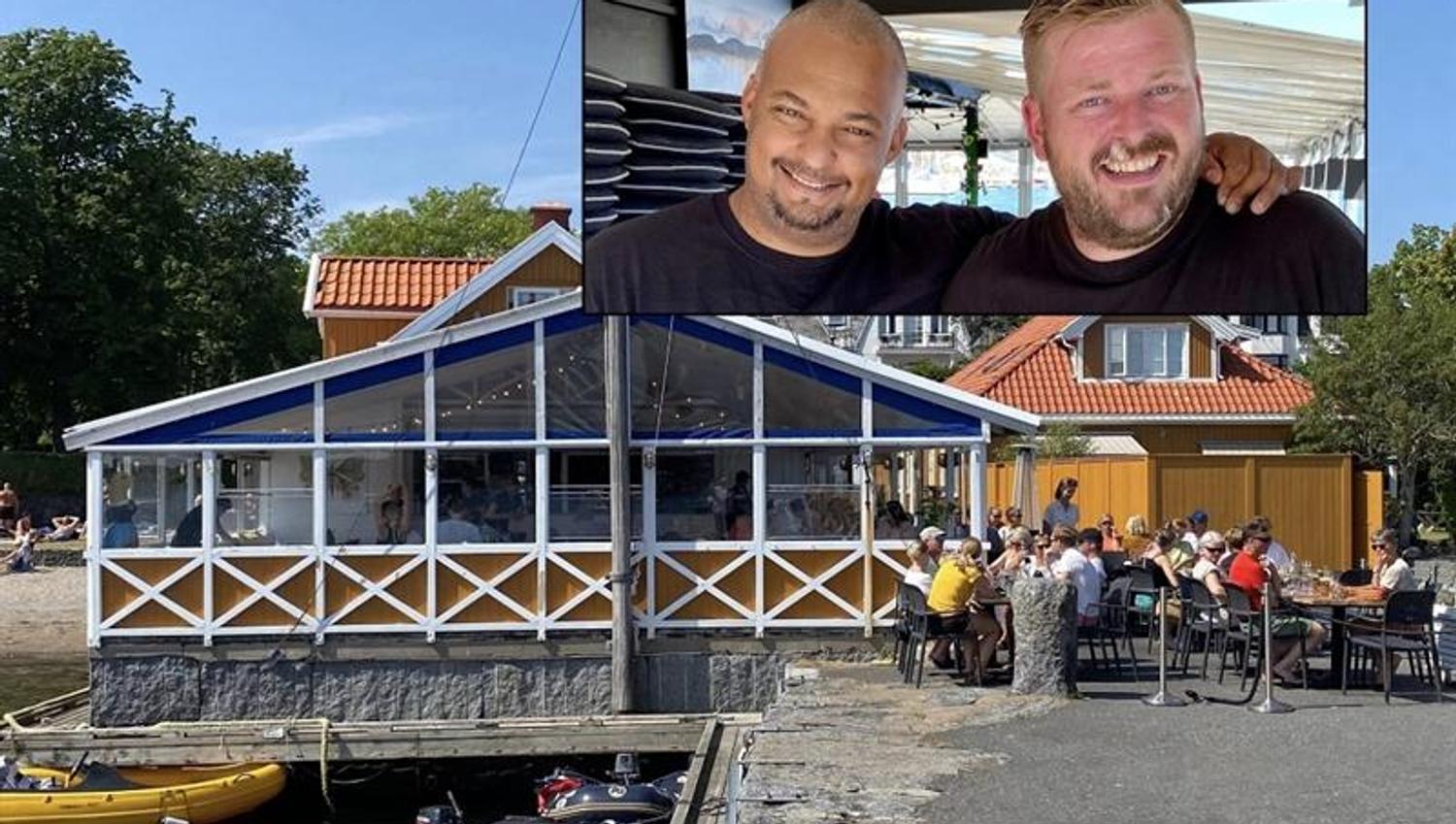 Uteserveringen ved Dampskipsbrygga Restaurant med gjester og sjøen like utenfor.