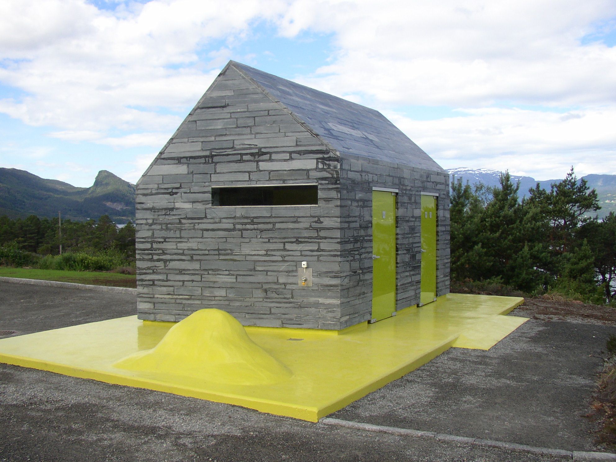 Architect-designed rest area toilet at Hereiane, surrounded by pine forest with views of mountains and fjord in Hardanger.
