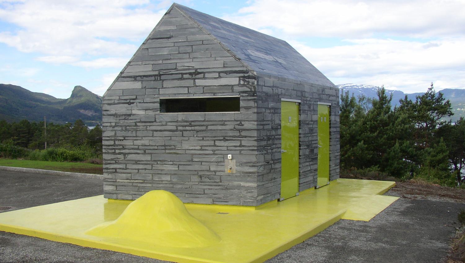 Architect-designed rest area toilet at Hereiane, surrounded by pine forest with views of mountains and fjord in Hardanger.