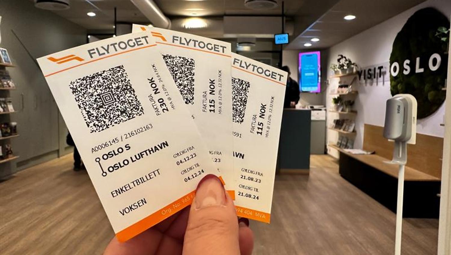 Detail of a hand holding three tickets for the Airport train