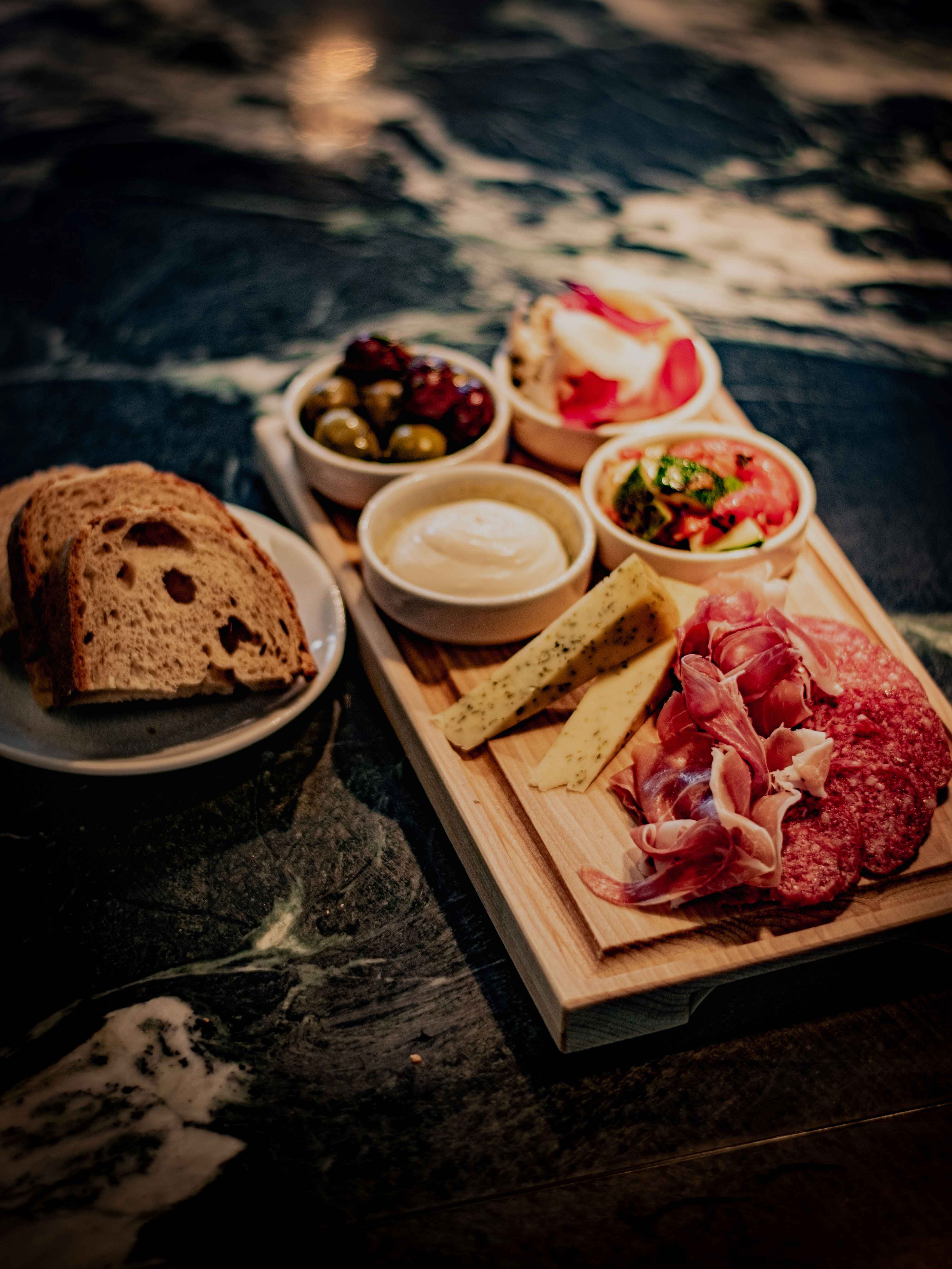 Nordic cuisine at Sjøhuset Norheimsund, elegantly plated on rustic ceramic dishware. Fresh local ingredients artfully arranged with seasonal garnishes