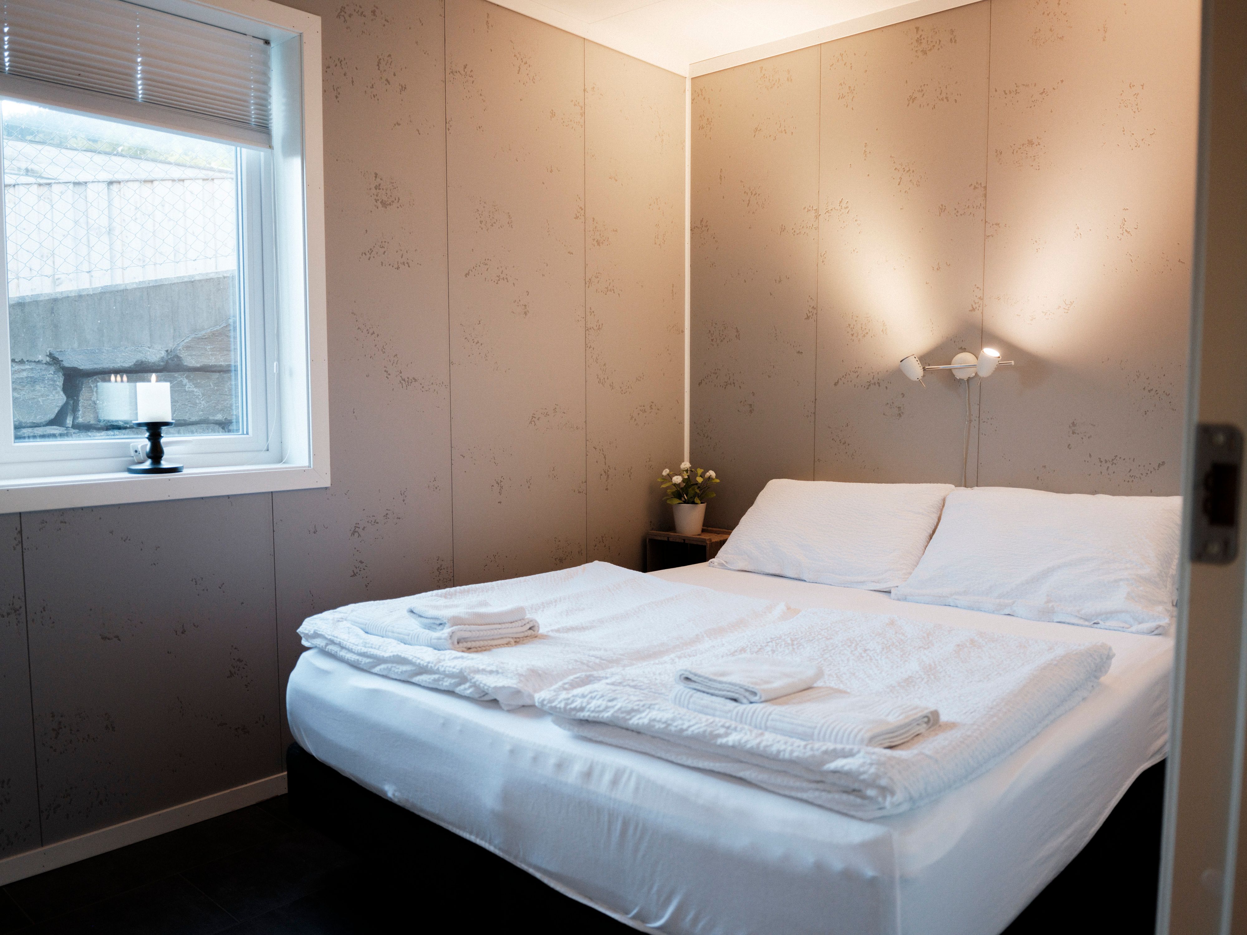 Modern bathroom with washing machine and shower at Aga Fjordapartments.