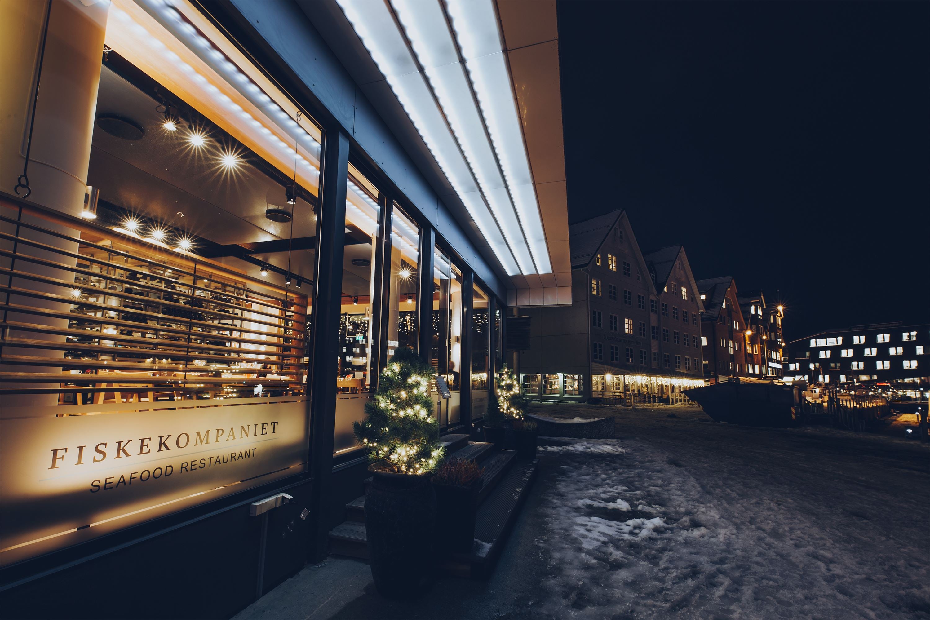 Outside view of the restaurant with the Tromsø city harbour behind