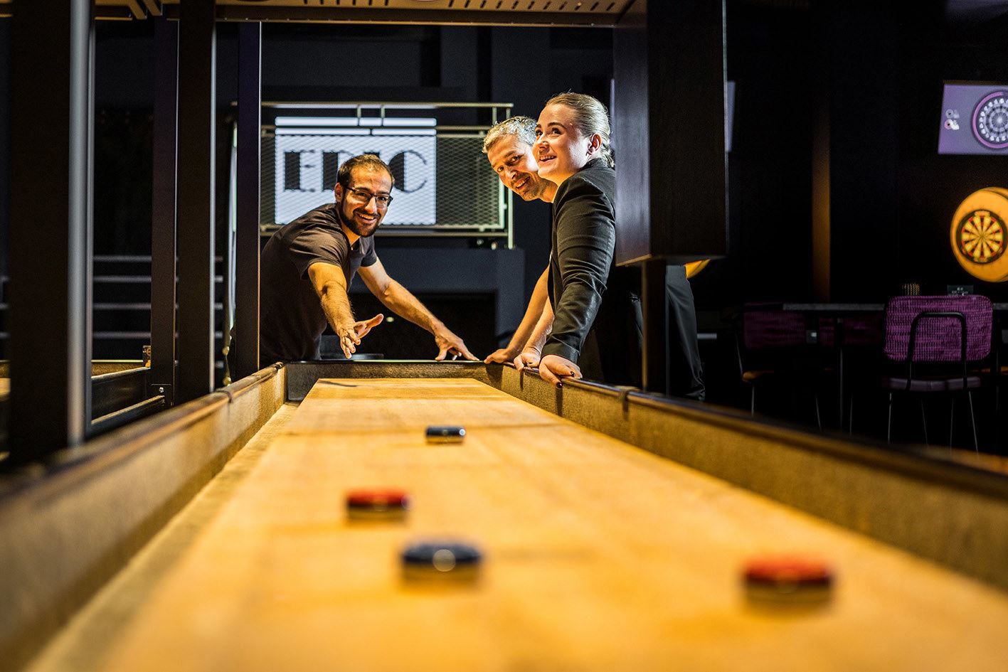 Guests playing shuffleboard at EPIC Tromsø.