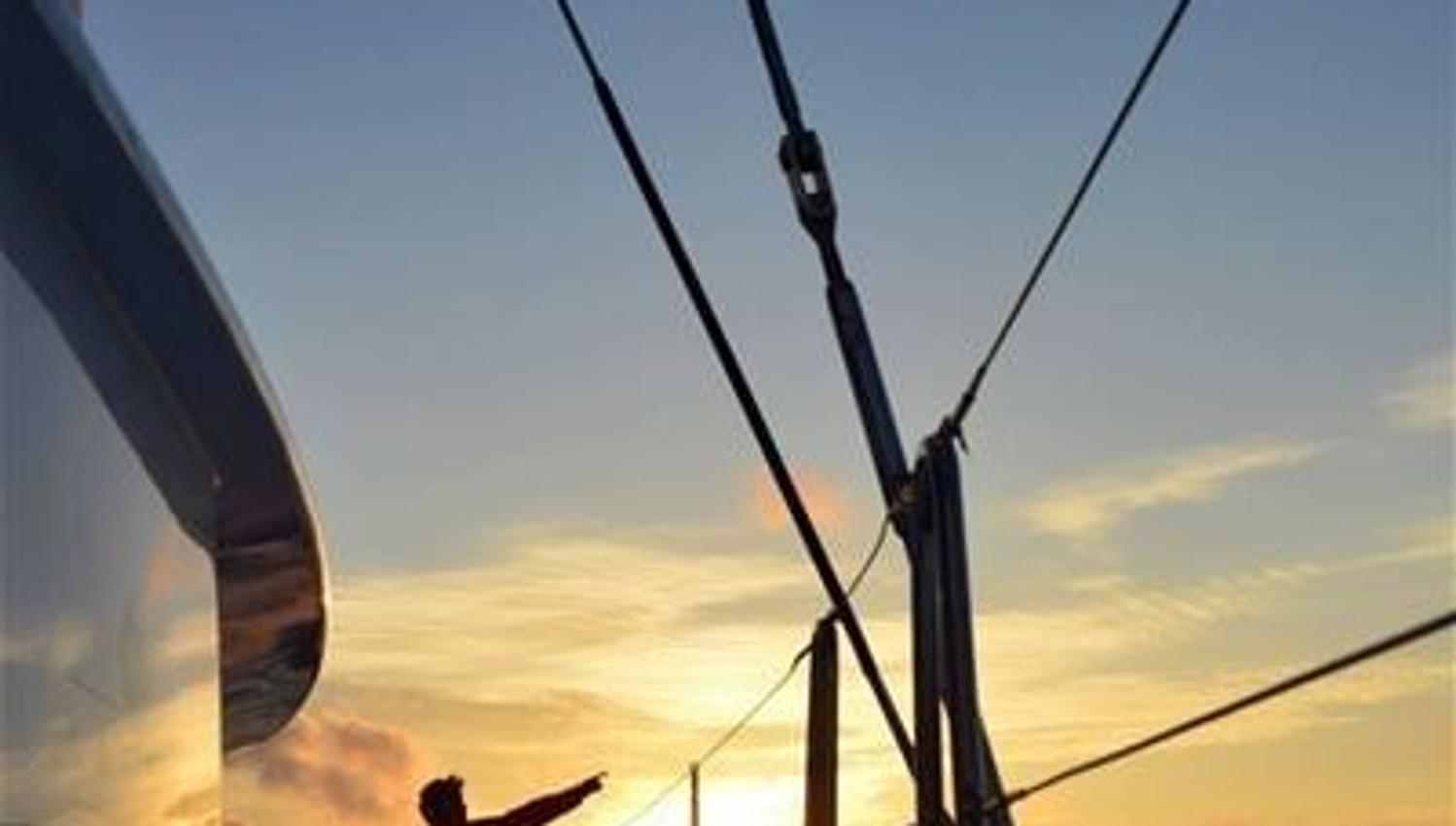 A person enjoying the view from the boat during the midnight sun