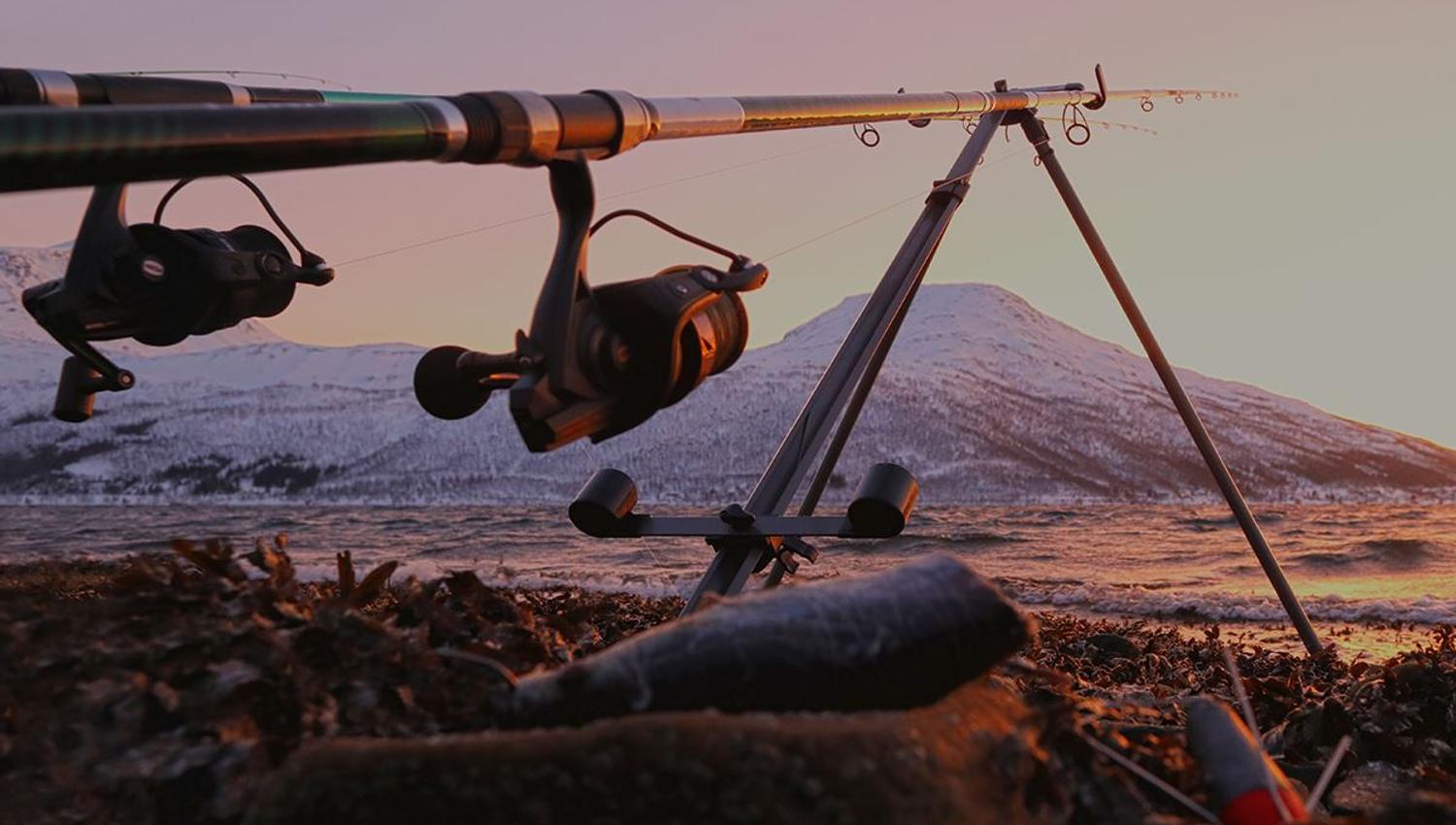 Fishing rod on a tripod with a scenic view in the background