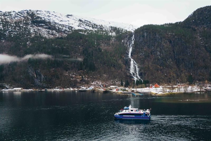 Steep mountains, fjord and waterfall