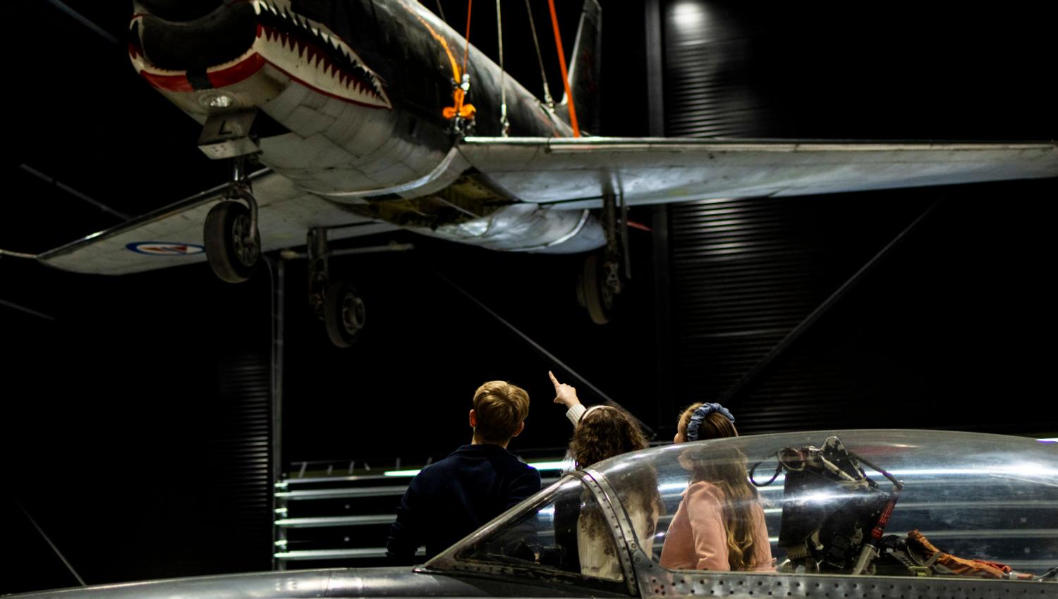 Guests study the fighter jets in the exhibition