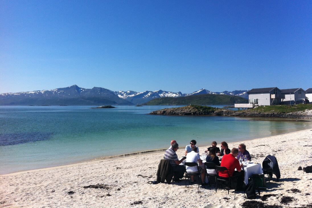 A group dining at a beach outside of Tromsø in Northern Norway