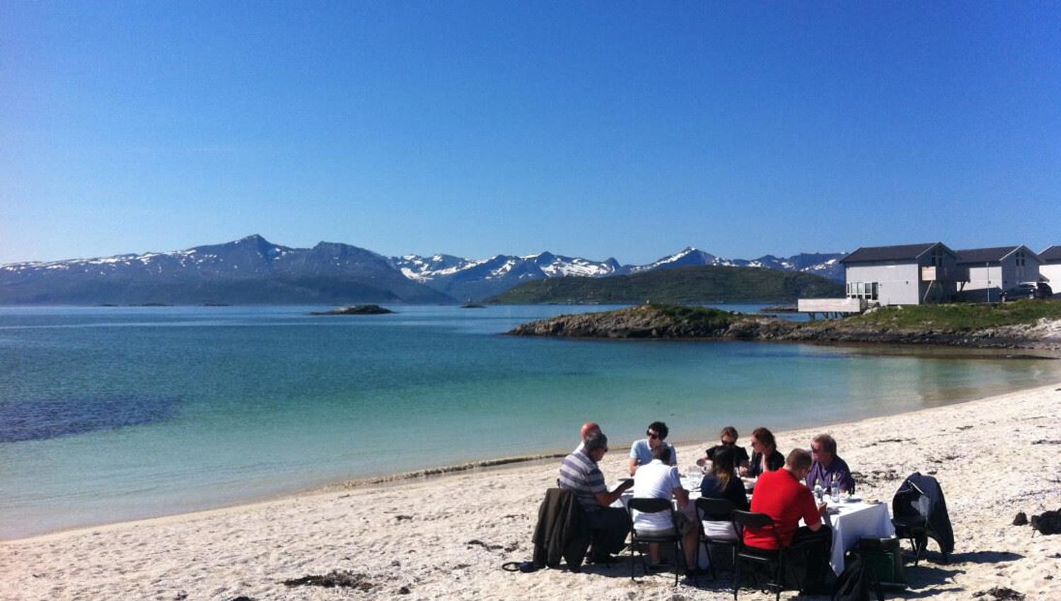 A group dining at a beach outside of Tromsø in Northern Norway