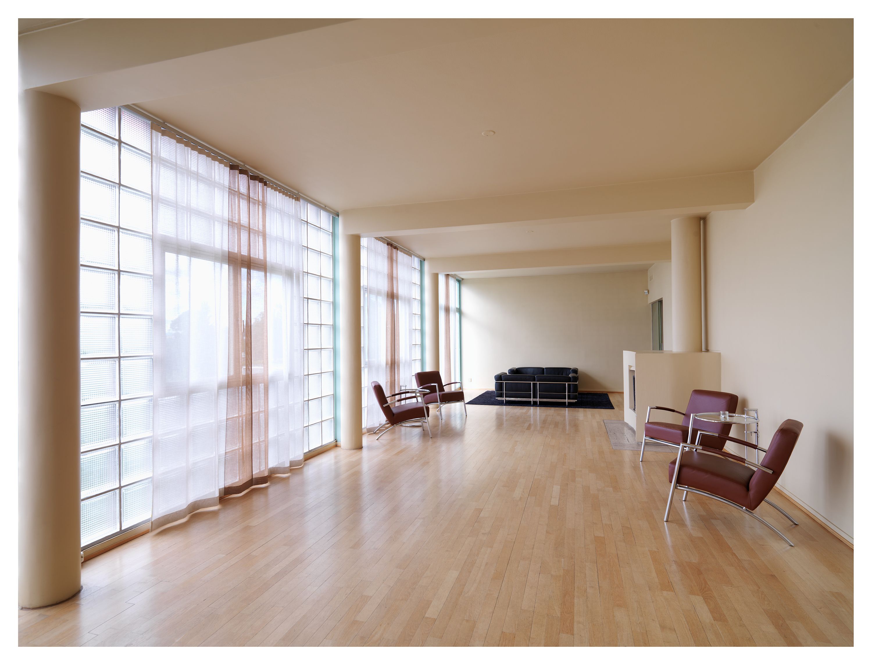 White-painted living room with large windows
