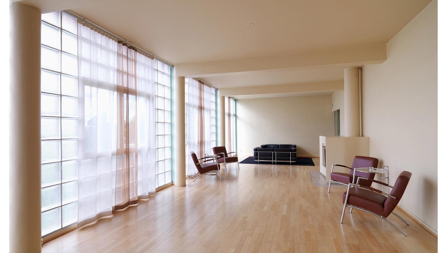 White-painted living room with large windows
