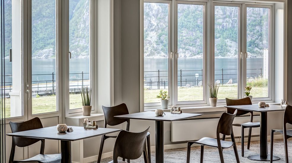 Tables and chairs next to the windows.