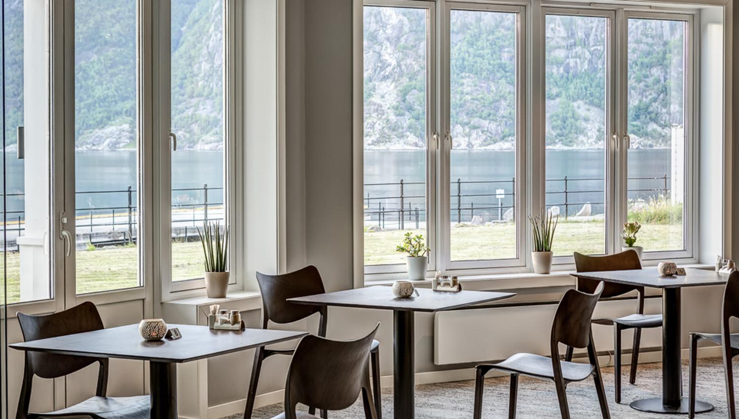 Tables and chairs next to the windows.